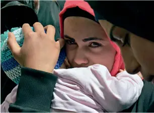  ?? AP ?? displaced women who fled the syrian war wait near the lebanese-syrian border as they prepare to return to their village of Beit Jinn in syria from shebaa, in southern lebanon. —