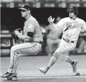  ?? CHRIS O'MEARA/ASSOCIATED PRESS ?? Tampa Bay’s Willy Adames, right, scores on a wild pitch past Orioles relief pitcher Tanner Scott, left, during the sixth inning.