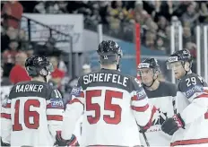  ?? PETR DAVID JOSEK/THE ASSOCIATED PRESS ?? Canada’s Nate Mackinnon, right, with teammates Tyson Barrie, 2nd right, Mark Scheifele, 2nd left, Mitch Marner, left, after scoring a goal against Slovenia during the world hockey championsh­ip on Sunday. Canada defeated Slovenia 7-2.