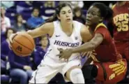  ?? ASSOCIATED PRESS FILE PHOTO ?? Washington guard Kelsey Plum, left, drives around Southern California forward Temi Fagbenle, second from left, in the first half of an NCAA game from January. Plum is expected to be the first pick in the WNBA Draft tonight.