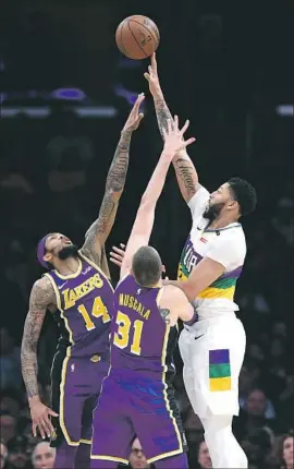  ?? Wally Skalij Los Angeles Times ?? ANTHONY DAVIS, here shooting over Lakers Brandon Ingram (14) and Mike Muscala, was the big prize landed in a deal agreed to by the Lakers and Pelicans.