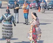  ?? Courtesy of Lynn Maday Bigboy, via The Associated Press ?? Singers and dancers use social distancing at a March 21 powwow outside the Bad River Casino in Ashland, Wis. The women are wearing jingle dresses.