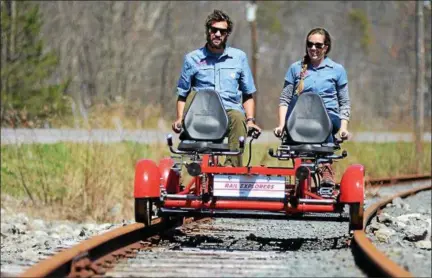  ?? TANIA BARRICKLO—DAILY FREEMAN ?? J.R. and Michelle Davis of Shandaken sit on one of the rail bikes on a section of track above the Esopus Creek outside of Phoenicia, N.Y. recently.