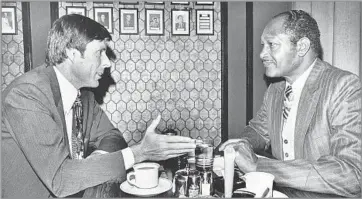  ?? Los Angeles Times ?? ‘I ABSOLUTELY ENJOYED THE WORK AND THE CHALLENGES’ Sen. John Tunney, left, and Mayor Tom Bradley discuss the energy crisis over breakfast at a restaurant in Los Angeles in 1974. Tunney was presumed to be the model for the Robert Redford character in...