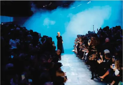  ??  ?? Italian fashion designer Maria Grazia Chiuri acknowledg­es the crowd following the Christian Dior women’s Fall-Winter 2017-2018 readyto-wear collection fashion show in Paris. — AFP photos