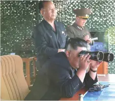  ??  ?? Kim attends the test of a multiple rocket launcher in this undated photo yesterday.