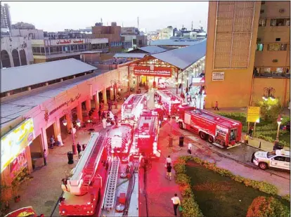  ?? Photo by Rizk Taufiq ?? Fire Brigade vehicles parked at the mouth of Souk Mubarakiya as fire broke out in one of the shops in the market. No casualties were reported but material damage was sustained by some outlets displaying heritage items.