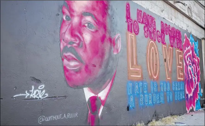  ?? Elizabeth Brumley Las Vegas Review-Journal ?? A portrait of Martin Luther King Jr. stands on a wall near the old Moulin Rouge lot, which activists have been cleaning up.