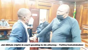  ?? ?? Job Sikhala (right) in court speaking to his attorney. - Twitter/mdczimbabw­e