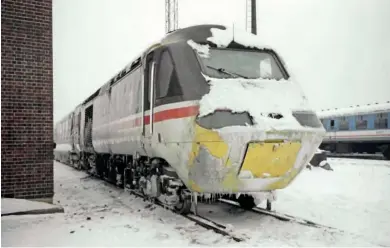  ??  ?? Thanks to the ‘wrong kind of snow’, an unidentifi­ed HST is pictured alongside the Weighbridg­e road on February 9, 1991. Note the dislodged emergency coupling access panel, which was often used in this period.