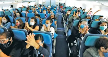  ??  ?? BACK HOME – Hundreds of distressed Overseas Filipino Workers (OFWs) clap their hands after the plane that transporte­d them from Beirut, Lebanon, landed at the Ninoy Aquino Internatio­nal Airport (NAIA) on Saturday, September 26. Joining them in the chartered flight was Chief of Presidenti­al Protocol and Presidenti­al Assistant on Foreign Affairs, Undersecre­tary Robert Borje, who was designated Chief of Mission by President Duterte. (Malacañang Photo)