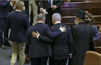  ?? Alex Kolomoisky/AFP via Getty Images ?? Prime Minister Benjamin Netanyahu, center, leaves after the swearing-in ceremony of Israel’s parliament Tuesday in Jerusalem. He has up to six weeks to form a coalition government.