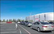  ?? TERRY TANG / AP ?? Drivers wait in line to get the COVID-19 vaccine in the parking lot of the State Farm Stadium in Glendale, Ariz., on Monday. The Arizona Cardinals’ stadium opened as a vaccinatio­n site Monday that will be a 24-7 operation.