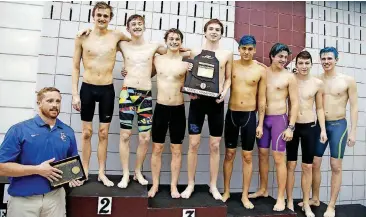  ?? [PHOTOS BY JAMES GIBBARD, TULSA WORLD] ?? The Deer Creek Antlers celebrate winning the Class 5A boys state swimming championsh­ip Saturday at the Jenks Aquatics Center. It was the Edmond school’s first swimming title.