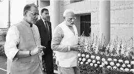  ?? PHOTO: PTI/PIB ?? Prime Minister Narendra Modi arrives at a national conference on ‘Doubling of Farmers Income by 2022’ in New Delhi on Tuesday, accompanie­d by Union Minister for Agricultur­e and Farmers Welfare Radha Mohan Singh