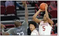  ?? (NWA Democrat-Gazette/Andy Shupe) ?? Freshman Moses Moody (right) led Arkansas in scoring for the second consecutiv­e game Saturday, finishing with 18 points, 8 rebounds and 3 assists in the Razorbacks’ victory over Lipscomb.