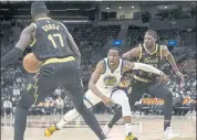  ?? CHRIS YOUNG — THE CANADIAN PRESS VIA AP ?? The Warriors’ Jonathan Kuminga, center, reacts as he loses possession during the second half Saturday in Toronto.