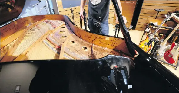  ?? PHOTOS: JIM BYERS/FOR POSTMEDIA NEWS ?? One of the pianos at the National Music Centre has been signed by top musicians, including Chuck Berry.