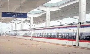  ?? ?? The Lane Xang bullet train pulls into the Vientiane railway station, the southern terminus of the US$5.9-billion Laos-China railway that has opened up new economic potential in the region.