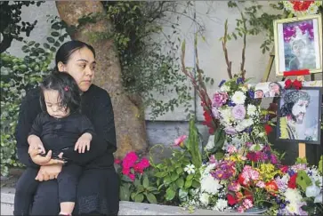  ?? Molly Duerig ?? “I T WAS A pain that was so big that I can’t explain it,” Anni Baltierra, with daughter Isabela, said of her son Christian Vega. Lighting was improved and a left- turn signal was installed near the crosswalk where he died.