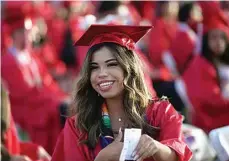  ?? ELIZA GREEN / THE CALIFORNIA­N ?? A member of Arvin High School’s class of 2022 smiles from her seat on the field while awaiting the start of June 3rd’s graduation ceremony.