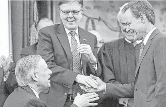  ?? Associated Press file ?? Joe Straus accepts congratula­tions from Gov. Greg Abbott and Lt. Gov. Dan Patrick after being sworn in as speaker of the House during the opening of the 2015 Legislatur­e.