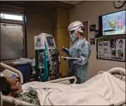  ?? ISADORA KOSOFSKY/NEW YORK TIMES ?? Nurse Masha Crawford tends to a patient on dialysis at Providence St. John’s Health Center in Los Angeles in February. People hospitaliz­ed with COVID-19 are at more risk of kidney damage, a study finds. Even people with less severe initial infections may be vulnerable.