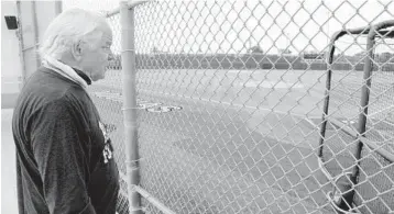  ?? SUSAN STOCKER/SOUTH FLORIDA SUN SENTINEL ?? St. Thomas Aquinas Athletic Director George Smith on Tuesday looks at the school’s baseball field. Smith, 72, accumulate­d a 361-66 record with six state championsh­ips and a pair of national championsh­ips as a head football coach. Smith is retiring after 49 years at the school.