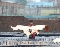  ?? AFP ?? A Bangladesh­i worker processes leather at a tannery in Dhaka. —