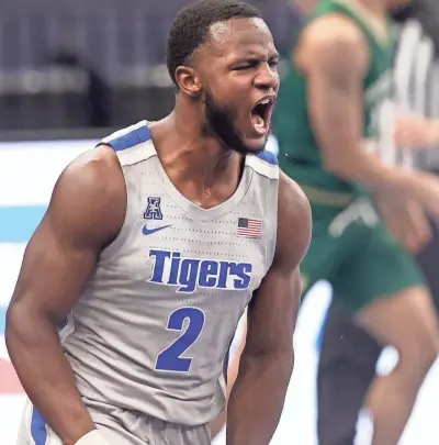  ?? JOE RONDONE/THE COMMERCIAL APPEAL ?? Memphis Tigers guard Alex Lomax screams out in celebratio­n after defending a last-second shot in their 58-57 win over the South Florida Bulls at the Fedexforum on Tuesday, Dec. 29, 2020