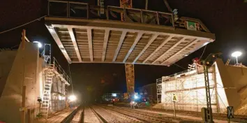  ?? Fotos: Thomas Heckmann ?? Ein Fest für Technik-Feinschmec­ker: Mit einem riesigen Raupenkran wurde neben dem Ulmer Industrieg­ebiet Donautal eine komplette Straßenbrü­cke über der Bahnlinie eingesetzt.