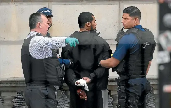  ?? PHOTO: REUTERS ?? Police restrain a man who was arrested while walking towards Downing Street with a rucksack packed with knives. It is understood that the man’s family became concerned about his behaviour and reported him to authoritie­s several weeks ago.