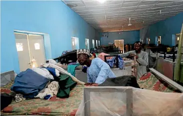  ?? AP ?? People inspect belongings of missing Government Science secondary school student at their hostel in Kankara.