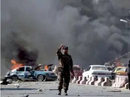  ?? — AFP ?? An Afghan security officer stands at the site of a truck bomb attack in Kabul on Wednesday.