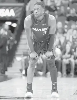  ?? DARREN ABATE/AP ?? The Heat’s Dwyane Wade rests on the court during a preseason game against the Spurs on Sept. 30. The Heat open the regular season on Oct. 17 on the road against the Magic.