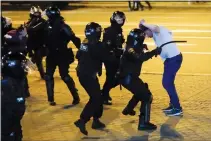  ?? (File Photo/AP) ?? Riot police clash with a protester Aug. 10, 2020, after the presidenti­al election in Minsk.