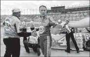  ?? JOHN SLEEZER/TRIBUNE NEWS SERVICE ?? Monster Energy NASCAR Cup Series driver Kevin Harvick is congratula­ted after winning the pole position during qualifying on May 11 at Kansas Speedway in Kansas City, Kan.