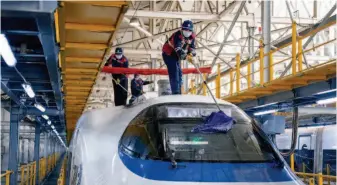  ??  ?? Workers of the High-speed Train Section of Beijing Railway Bureau daily disinfect bullet trains from end to end. At the critical moment of the outbreak of the novel coronaviru­s epidemic, the High-speed Train Section of Beijing Railway Bureau undertakes the task of high-speed rail transporta­tion nationwide and also provides transport support for relief supplies to Wuhan, the epicenter of the epidemic. by Xu Xun/china Pictorial