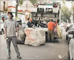  ?? Jordi Ruiz Cirera For The Times ?? BELL RINGER Juan Carlos Velasquez heralds the garbage truck’s arrival, signaling to Mexico City residents that it’s time to haul out the trash.