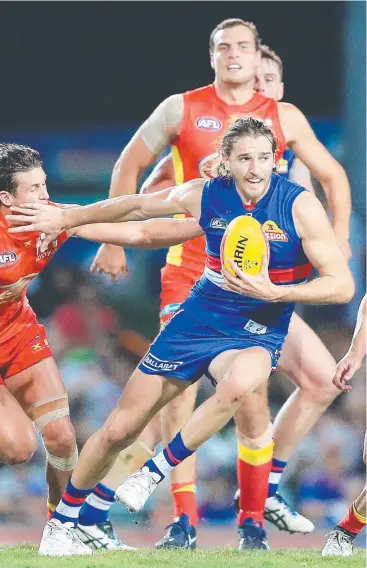  ?? Picture: JUSTIN BRIERTY ?? TASTE OF FNQ: Western Bulldogs star Marcus Bontempell­i breaks through the Gold Coast defence during an AFL premiershi­p match at Cazalys Stadium in 2017.