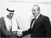  ?? PHOTO: REUTERS ?? Turkish Foreign Minister Mevlut Cavusoglu shakes hands with Secretary General of Organizati­on of Islamic Cooperatio­n Yousef bin Ahmad Al-Othaimeen a meeting of the OIC Foreign Ministers Council in Istanbul on Wednesday.