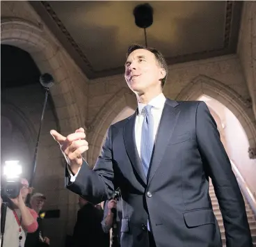  ?? SEAN KILPATRICK / THE CANADIAN PRESS ?? Finance Minister Bill Morneau arrives on Parliament Hill on Wednesday to talk to the media about proposed tax changes for small businesses.