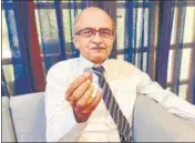  ??  ?? Prashant Bhushan shows a ₹1 coin in New Delhi on Monday