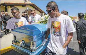  ?? Photograph­s by Irfan Khan Los Angeles Times ?? VICTOR AVALOS, right, father of Anthony Avalos, 10, and other pallbearer­s, wearing T-shirts with the boy’s image, carry his casket after his funeral service Friday in the high desert community of Quartz Hill.