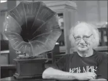  ??  ?? Jean Belisle poses next to a 1902 gramophone at the museum.