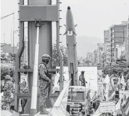  ?? ARASH KAMOOSHI The New York Times ?? In 2022 during the Quds Day march in Tehran, Iran’s Islamic Revolution­ary Guard Corps displays what was described as new long-range ballistic missiles.