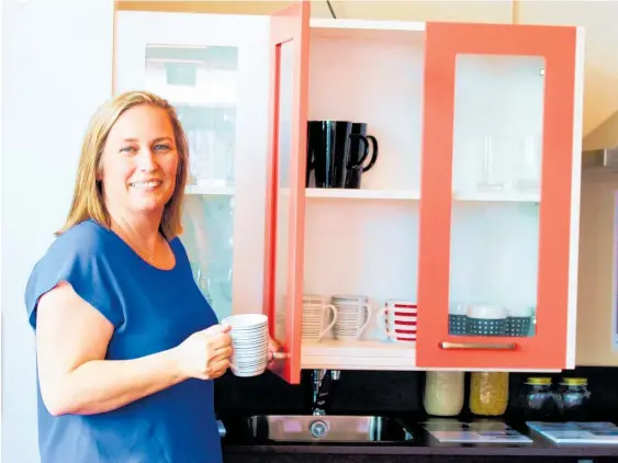  ?? Photos / Judith Lacy ?? Enable business developmen­t manager Andrea Crutchley with the moveable kitchen cupboard in Easie Living’s demonstrat­ion centre.