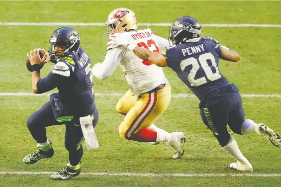  ?? CHRISTIAN PETERSEN/GETTY IMAGES ?? Eight-time Pro Bowl quarterbac­k Russell Wilson, left, is said to want to leave the Seattle Seahawks after a falling out with the team's coaches.