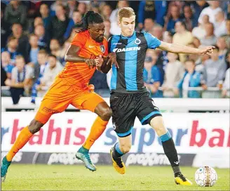  ?? (AFP) ?? Basaksehir’s Emmanuel Adebayor (left), and Club’s Brandon Mechele fight for the ball during the first leg of the third qualifying round football match for the UEFA Champions League competitio­n between Belgian team Club
Brugge KSV and Turkish club...