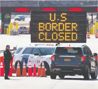  ?? CHRISTINE MUSCHI/ BLOOMBERG; LARS HAGBERG/AFP VIA GETTY IMAGES ?? Top, a migrant worker stands inside a trailer while starting a 14- day quarantine at a farm in Notre-dame- de-l’ile-perrot, Que., on May 8. Above, U. S. Customs officers speak with people in a car beside a sign saying that the U. S. border is closed at the border in Lansdowne, Ont., on March 22.